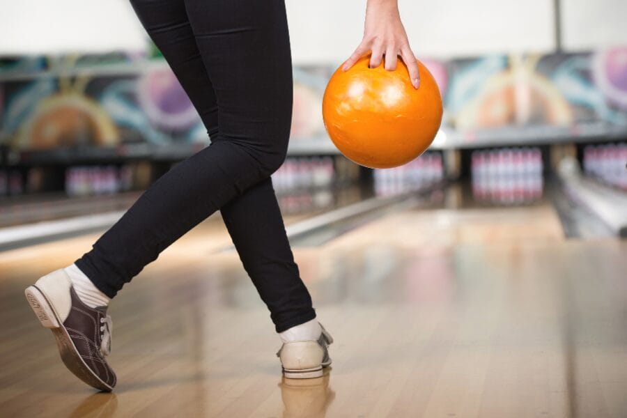 an image of someone preparing to roll a bowling ball down a lane